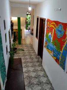 a hallway of a house with a mural on the wall at Jurema Hostel in Itacaré