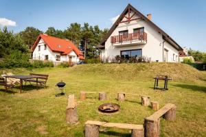 a house on top of a hill with a grill at Ginger Apartament in Wilkasy