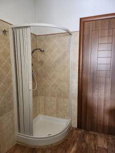 a shower with a glass door in a bathroom at Domus Mariposa in Tortolì