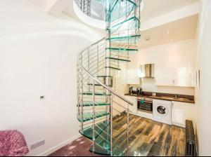 uma escada em espiral numa cozinha com uma lavandaria em Seaside Home em Ardeer Square