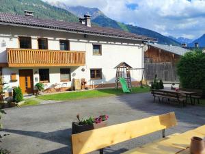 a building with a picnic table and a playground at Ferienwohnungen Momo in Elbigenalp