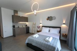 a bedroom with a bed with two towels on it at Gaia Apartments I in Anthoúsa +26 photos