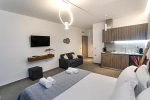 a bedroom with a bed and a couch in a room at Gaia Apartments Parga in Parga
