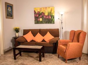 a living room with a couch and a chair at Apartamento Fernando Colón en Casco Histórico in Córdoba