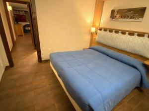 a bedroom with a blue bed in a room at Maison Maribel 0043 in Pré-Saint-Didier