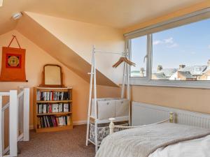 a bedroom with a bed and a book shelf at Castle View in Scarborough