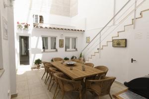a dining room with a wooden table and chairs at Sitges Centre Mediterranean House- 5 Bedroom, 4 Bathroom, Terrace Courtyard, Private Rooptop Pool in Sitges
