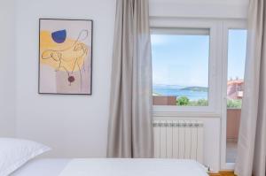 a bedroom with a bed and a window at Apartment Skoko in Slatine