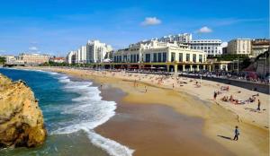 a view of a beach with people on it at Biarritz centre, près avenue de Verdun- Plage et casino à 10 mn à pied- 4 personnes -RDC in Biarritz