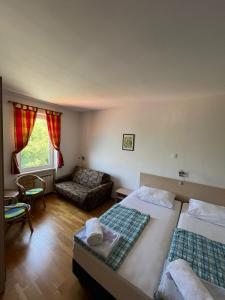 a hotel room with two beds and a couch at Bed&Breakfast Villa Eva in Omišalj +30 photos