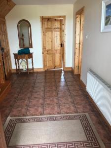 a hallway with a door and a tile floor at Atlantic View in Castlegregory