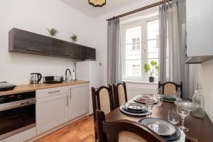 a kitchen with a table and a dining room at APARTAMENT VINTAGE parter in Płock