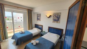 a hotel room with two beds and a window at Le Mirage Ibiza in San Antonio +59 photos