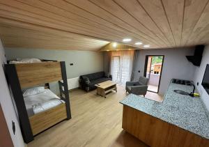 a room with a bunk bed and a living room at Aderfia Suite in Uzungöl
