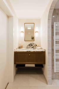 a bathroom with a sink and a mirror at Clemonte Hotel - Your Reception-less Boutique Hideaway in Salzburg