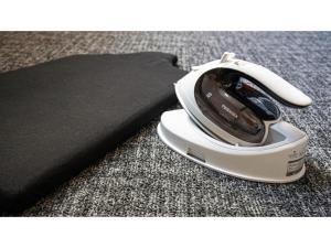 a white iron sitting on the floor next to a pillow at Hotel Torifito Kashiwanoha - Vacation STAY 75950v in Kashiwa