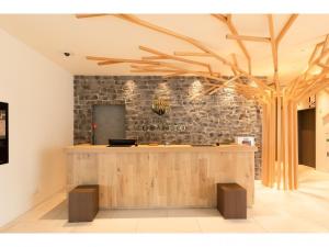a bar in a room with a stone wall at Hotel Torifito Kashiwanoha - Vacation STAY 75950v in Kashiwa