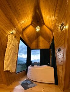 a room with a large window in a wooden building at Vista cottage in Stepantsminda