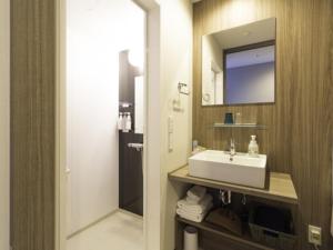 La salle de bains est pourvue d'un lavabo et d'un miroir. dans l'établissement La'gent Stay Hakodate Ekimae - Vacation STAY 75056v, à Hakodate