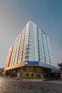 a large building with a sign on the front of it at Hotel Clarion Suites Guatemala in Guatemala