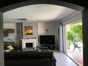 ein Wohnzimmer mit einem Sofa und einem Kamin in der Unterkunft Maison avec piscine et vue sur les collines. in Marseille