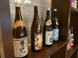 four bottles of wine sitting on a shelf at Yaizu - House - Vacation STAY 14728 in Yaizu