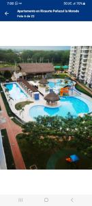 a picture of a large swimming pool in a city at Hermoso Apartamento Ricaurte Peñazul La Morada. in Ricaurte