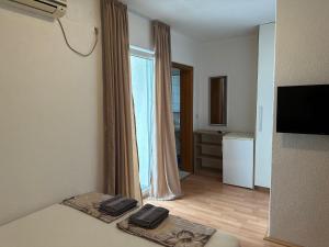 a room with a bed and a large window at Royal Apartments in Neum