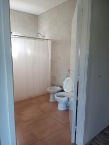a bathroom with a toilet and a bidet at Finca Casiana in Villa Krause