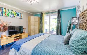 a blue bedroom with a bed and a tv at Beautiful Home In Septfonds With Outdoor Swimming Pool, Wifi And 1 Bedrooms in Septfonds