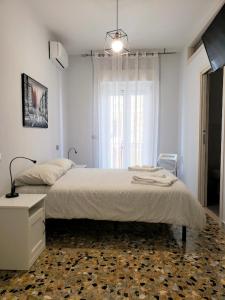a bedroom with a large bed and a window at Dimora Mastcarrir in Monte SantʼAngelo