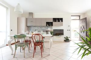a kitchen with a white table and chairs at Apartment MisiAdele in Carnago
