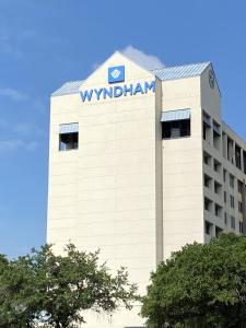 a building with a sign on the top of it at Wyndham Houston near NRG Park - Medical Center in Houston