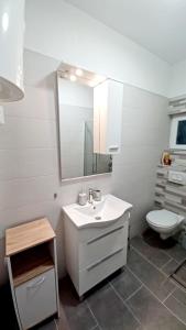 a bathroom with a white sink and a toilet at Tonka in Vodice