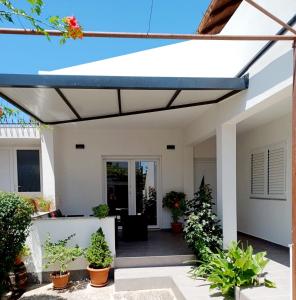 awning over a porch of a house with plants at Tonka in Vodice