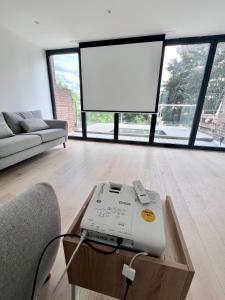 a fax machine sitting on a table in a living room at Beautiful 5-bedroom private house in quiet London street 2 minutes from station in London