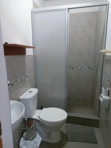 a bathroom with a toilet and a shower at Majestic Mical in Yurimaguas +35 photos