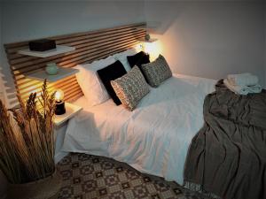 a bedroom with a large white bed with pillows at BS apartamentos Aledo14 in Novelda