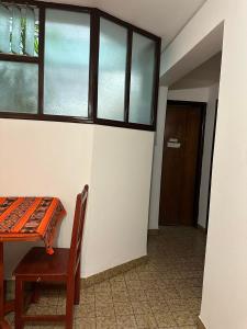 a room with a table and a chair and a door at Apart Centro- VICTORIA555 in Libertador General San Martín