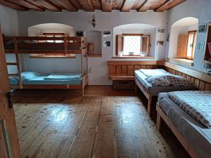two bunk beds in a room with wooden floors at Pr Močnk in Bled