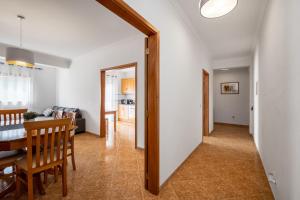 a dining room and living room with a table and chairs at Porto Santo Apartment in Nazaré