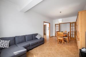 a living room with a couch and a table at Porto Santo Apartment in Nazaré