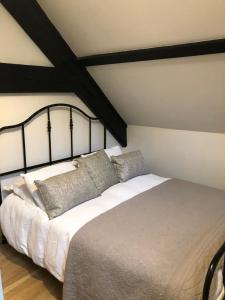 a bedroom with a large bed with pillows on it at Lanehead Old School in Lanehead