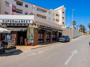 a car parked in front of a building on a street at Cubo's Beach Front Villa Benalmadena in Torremuelle