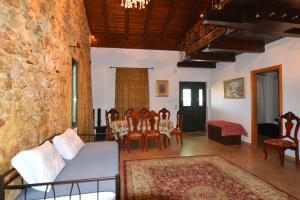 a living room with a couch and a table and chairs at Erietas House in Chania Town