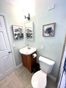 a bathroom with a white toilet and a sink at Palm Paradise in downtown Cocoa Beach in Cocoa Beach