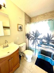 a bathroom with a sink and a toilet and a shower at Palm Paradise in downtown Cocoa Beach in Cocoa Beach