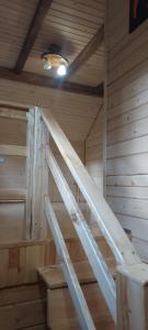 a wooden ladder in a room in a sauna at Крайня Хата in Synevyrsʼka Polyana