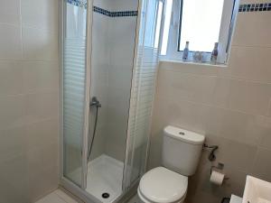 a bathroom with a toilet and a glass shower at Goldy Centre Home in Rethymno Town