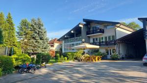 a building with motorcycles parked in front of it at Riverside Resort Una in Bihać